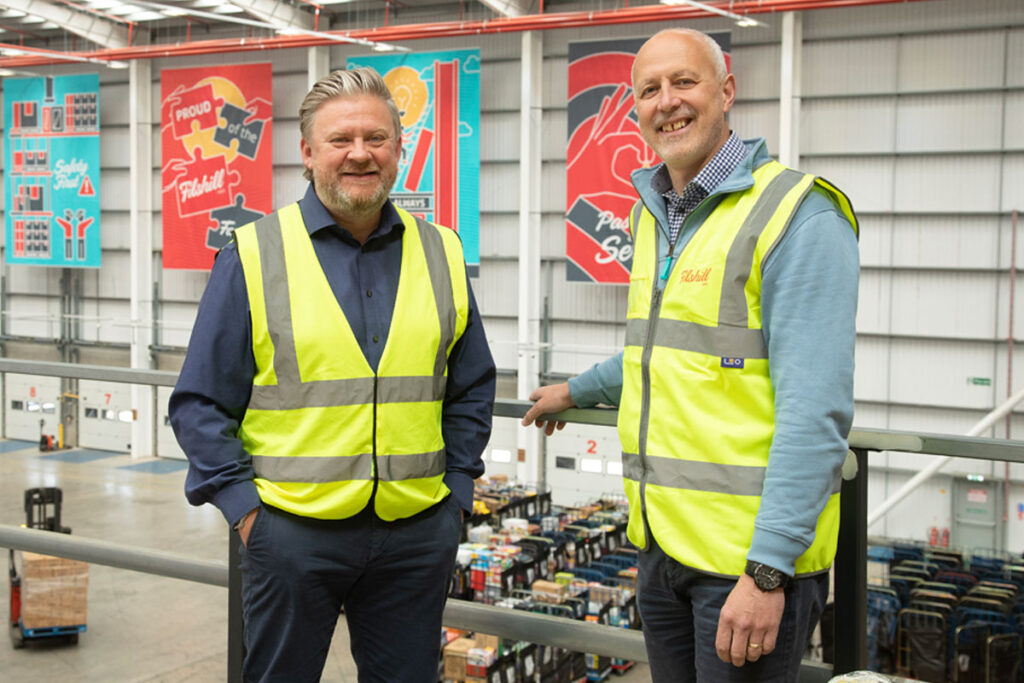 Simon Hannah, left, chief executive at JW Filshill stands inside the wholesaler's depot with Keith Geddes, right, chief financial and operating officer at Filshill.