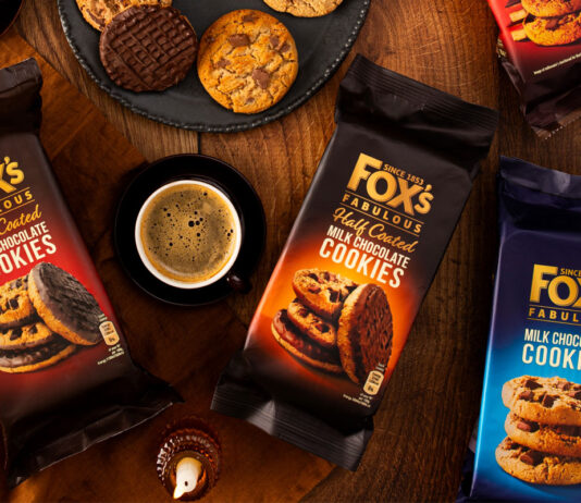 Drive up Mother’s Day sales with Fox’s gift ideas Packets of Fox's Fabulous biscuits sit on a table with biscuits placed onto plates with a mug of coffee between two packs of the biscuits – the biscuit variants include Half Coated Dark Chocolate Cookies, Half Coated Milk Chocolate Cookies, Milk Chocolate Cookies.