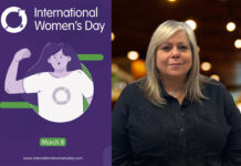 An image of a poster for International Women's Day is to the left with Karen Mulesh, catering sales controller at Booker, to the right of the image.