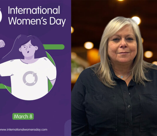 International Women’s Day – Booker Group An image of a poster for International Women's Day is to the left with Karen Mulesh, catering sales controller at Booker, to the right of the image.