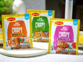 Packets of Maggi Air Fryer Crispy Coating range stand on a kitchen table including the Southern Style, Katsu Style and Korean BBQ Style variants.