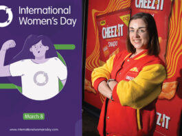 International Women’s Day – Londis Solo Convenience Baillieston Natalie Lightfoot, store owner at Londis Solo Convenience Baillieston, stands wearing a Cheez-It branded jacket with an advert for the brand behind her with a picture of the post for International Women's Day 2025.