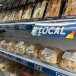 SGF Go Local Programme is renewed for another year A chiller with sandwiches and rolls with strip runners along the shelving with the SGF Go Local branding across it, the text reads 'We Support Local'.
