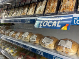 SGF Go Local Programme is renewed for another year A chiller with sandwiches and rolls with strip runners along the shelving with the SGF Go Local branding across it, the text reads 'We Support Local'.