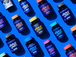Vitawell revamps health supplements range Bottles of Vitawell Vitamins and Supplements are lying down against a blue background, the bottles all have lids of varying colours to match the variant and the colour matches the text found on the bottle.