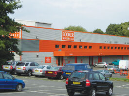 Booker symbol groups to benefit from Beer & Cider and Wine Festivals Exterior image of Booker Longstone depot in Edinburgh with cars in the car park.