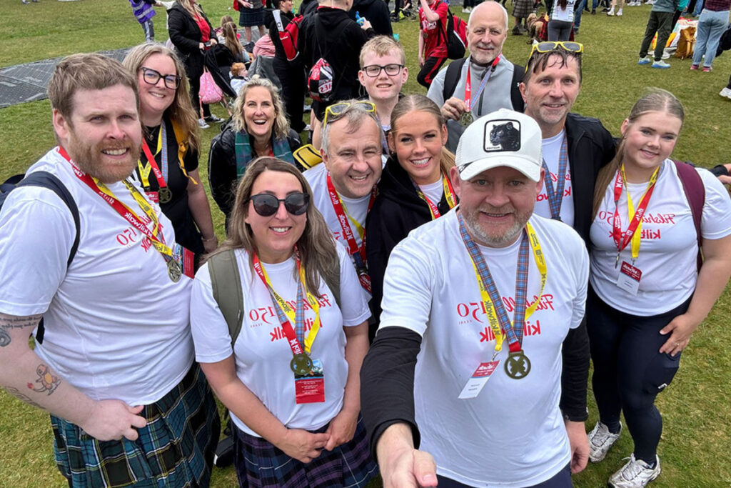 The JW Filshill team stand together to take a selfie after completing the Glasgow Kiltwalk.