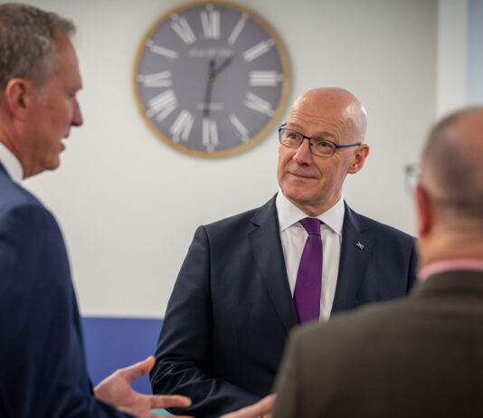 First Minister visits Highland Spring’s Blackford site First Minister of Scotland John Swinney stands talking to two men at the Highland Spring Group's Blackford site in Perthshire.