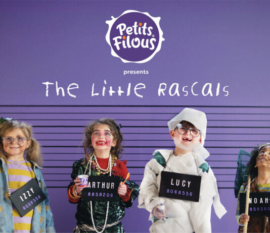 Petits Filous kicks off campaign to highlight healthy yoghurts Four children are lined up against a police wall with purple walls as they are covered in mess as though they have been caught by their parents. Each holds a board with their name on it, on the wall behind them is the Petits Filous logo and the text 'The Little Rascals'.