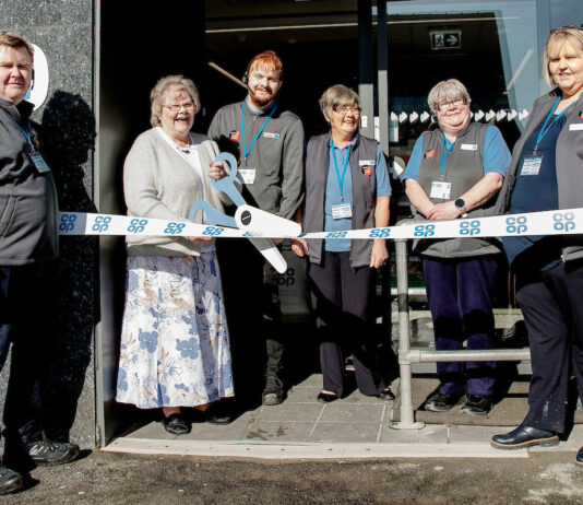 Co-op reopens its store in Skye A group of locals help to open Portree Co-op in Skye with a novelty pair of scissors being used to cut the ribbon at the store's door.