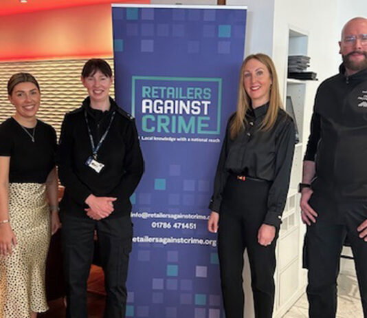 Retailers Against Crime highlight scourge at seminar RAC Intelligence Co-ordinator Natasa Wilson, PC Evelyn Hegarty, RAC National Operations Manager Stephanie Karte and a John Lewis Profit Protection Partner (L to R) stand around a Retailers Against Crime display.