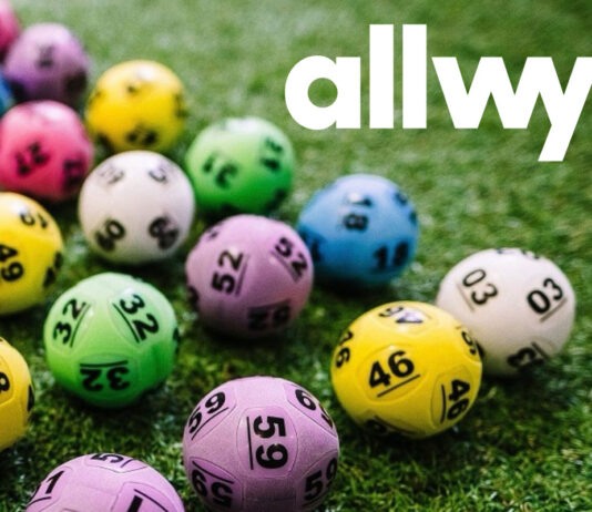Allwyn offers support for National Lottery retailers Multi-coloured National Lottery balls lie on grass with the Allwyn logo in the top right hand corner.