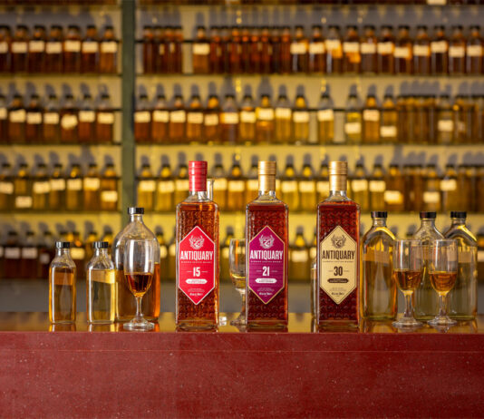 The Antiquary rolls out whisky gift ideas for Father’s Day Bottles of The Antiquary whisky are lined up on a bar featuring the 15 Year Old, 21 Year Old and 30 Year Old. Along with these bottles, there are smaller sample bottles for blending as well as whisky glasses to serve in with unlabelled whisky sample bottles on shelves behind the bar.