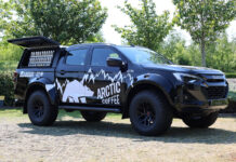 An Arctic Coffee branded Izuzu D-Max Arctic Truck is parked with its side window open with bottles of the chilled coffee available for sale.