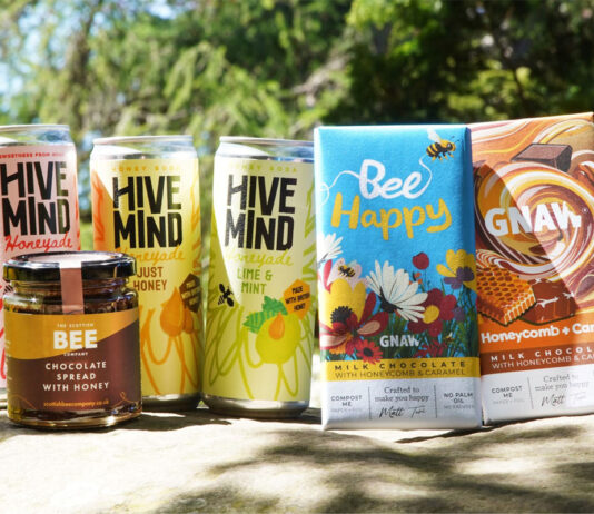 Trio of bee-corp brands unite for World Bee Day Cans of Hive Mind Honeyade, The Scottish Bee Company Chocolate Spread with Honey jar and bars of GNAW Chocolate with Honeycomb and Caramel are all grouped together to mark World Bee Day.