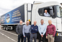 A group of people stand in front of a Spar Scotland lorry with the new livery highlighting its winning streak at the Scottish Wholesale Association's Achievers Awards with its three Symbol Group of the Year wins.