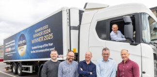 A group of people stand in front of a Spar Scotland lorry with the new livery highlighting its winning streak at the Scottish Wholesale Association's Achievers Awards with its three Symbol Group of the Year wins.