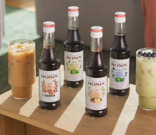 Monin aims to shake up at home iced drinks with concentrate range Bottles of Monin Concentrate variants including Cold Brew, Matcha Green Tea, Chai Tea and Blueberry Matcha Green Tea with iced coffee serves in the glasses around them.