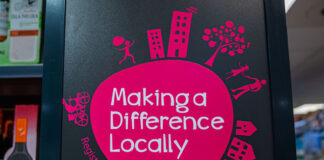 Co-op Wholesale's Making a Difference Locally logo inside a store.