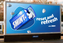 A billboard at a train station with the Smint summer campaign 2025 on it. The tagline reads 'Reset and Refresh'.