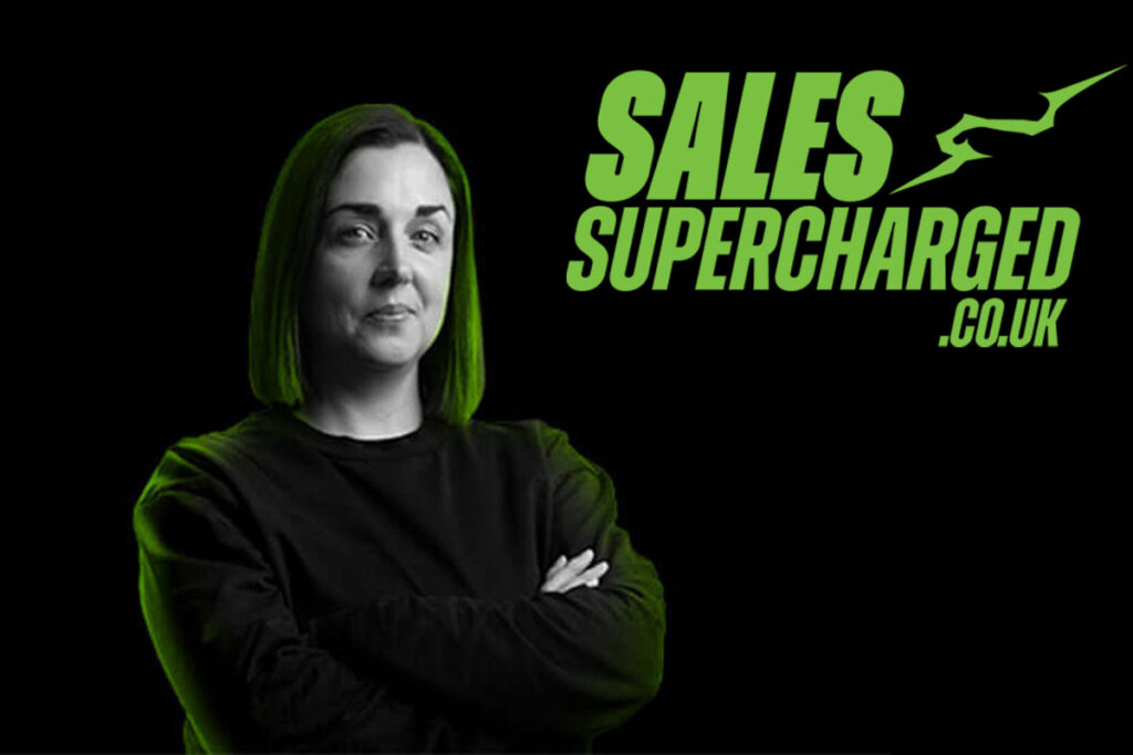 Glasgow retailer Natalie Lightfoot stands against a black background with green lighting shining down on her head with the SalesSupercharged.co.uk logo in the top right corner.