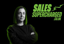 Glasgow retailer Natalie Lightfoot stands against a black background with green lighting shining down on her head with the SalesSupercharged.co.uk logo in the top right corner.