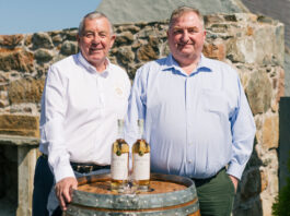Saltire Rare Malt marks first year of business with new whisky bottling Saltire Rare Malt Founders Nigel Heywood and Keith Rennie (left to right) stand behind a whisky barrel with two whisky bottles on top of the barrel and a nosing glass in front of the whisky bottles.