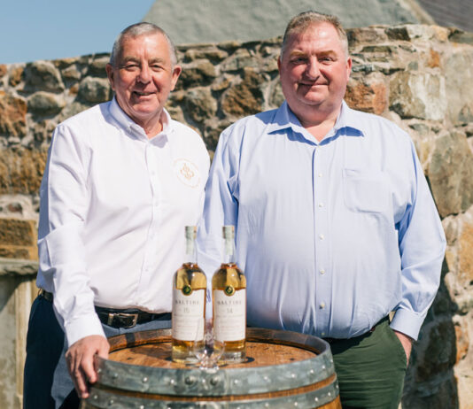 Saltire Rare Malt marks first year of business with new whisky bottling Saltire Rare Malt Founders Nigel Heywood and Keith Rennie (left to right) stand behind a whisky barrel with two whisky bottles on top of the barrel and a nosing glass in front of the whisky bottles.