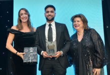 Three people standing on a stage to accept an award at the Scottish Grocer Awards 2024.