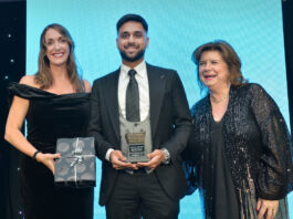 Awards Profile – Symbol Store of the Year (Single) Three people standing on a stage to accept an award at the Scottish Grocer Awards 2024.