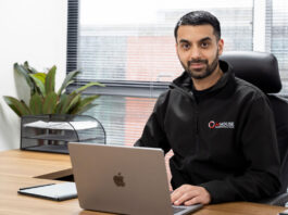 MHouse takes a deeper focus on retailer experience Faisal Sattar, chief executive at MHouse, sits behind a desk with an Apple Mac laptop on it.