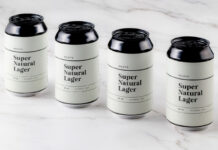 Cans of Roley's Super Natural Lager stand on a marble worktop.