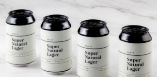Cans of Roley's Super Natural Lager stand on a marble worktop.