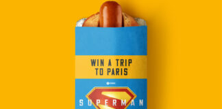 Rollover Hot Dog with branding on the top of it featuring Superman (2025) offering consumers the chance to win a trip to Paris.