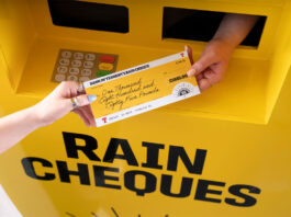 Tennent’s braves the summer with new 140th anniversary campaign A hand passing out a cheque for £1885 with a Tennent's lager design across the cheque and the ATM machine.