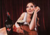 Pop star Sophie Ellis-Bextor sits at a table with an Espresso Martini in hand with a bottle of Tia Maria Cold Brew next to the cocktail serve.