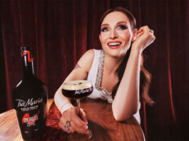 Pop star Sophie Ellis-Bextor sits at a table with an Espresso Martini in hand with a bottle of Tia Maria Cold Brew next to the cocktail serve.