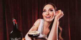 Pop star Sophie Ellis-Bextor sits at a table with an Espresso Martini in hand with a bottle of Tia Maria Cold Brew next to the cocktail serve.