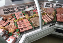 Butchery counter with a range of meat products lined up.