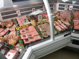 Butchery counter with a range of meat products lined up.