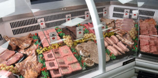 Butchery counter with a range of meat products lined up.