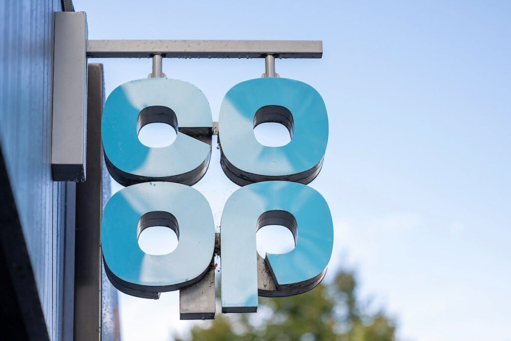 Co-op sign hanging outside of a Co-op store.