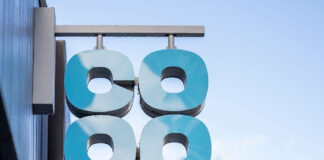 Co-op sign hanging outside of a Co-op store.