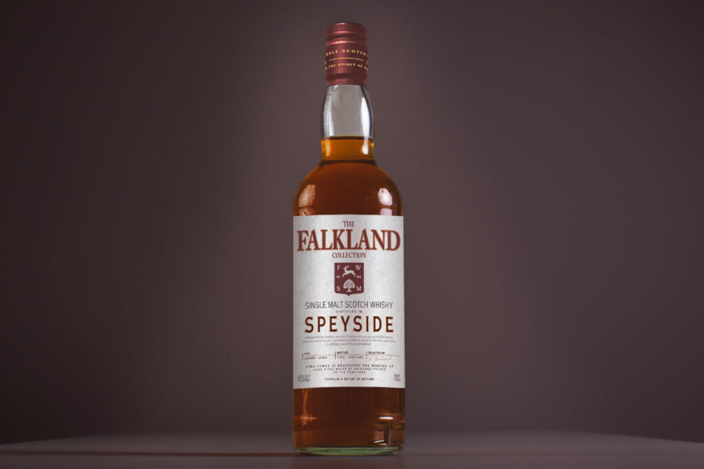 A bottle of Falkland Whisky is against a dark background.