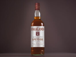 A bottle of Falkland Whisky is against a dark background.