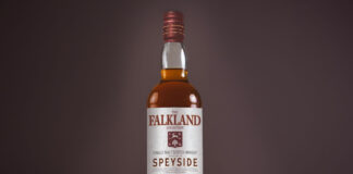 A bottle of Falkland Whisky is against a dark background.