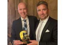Craig Brown (left) and Chris Miller (right) stand together holding Grocer Gold award.