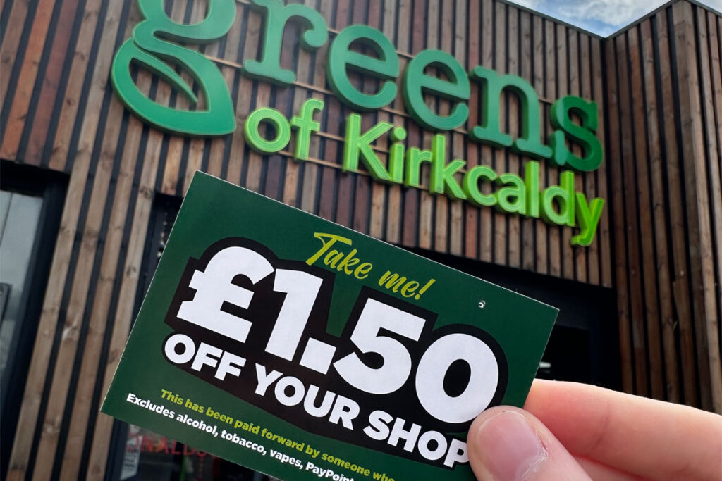 A person holds a £1.50 off voucher for use in Greens Retail stores outside of Greens of Kirkcaldy.