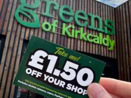 A person holds a £1.50 off voucher for use in Greens Retail stores outside of Greens of Kirkcaldy.