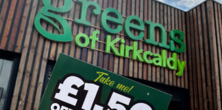 A person holds a £1.50 off voucher for use in Greens Retail stores outside of Greens of Kirkcaldy.